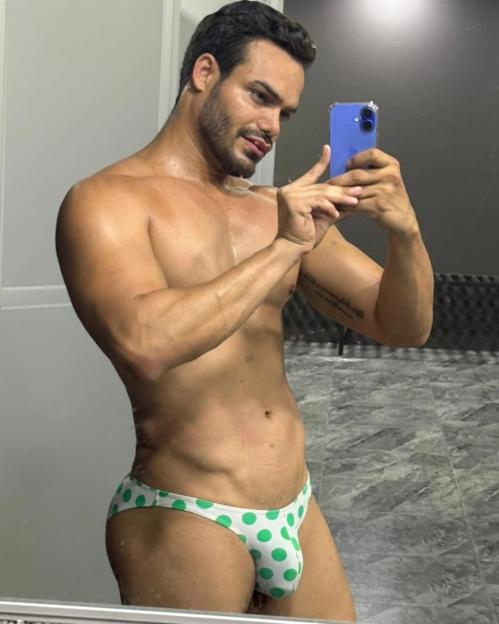 Emilio Sueños shirtless in green polka dot underwear.