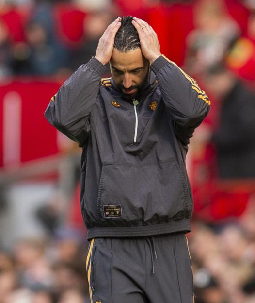 Ruben Amorim, manager of Manchester United, holding his head in his hands.