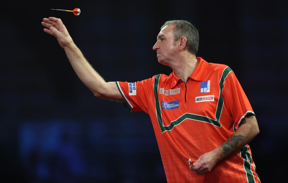 Richie Burnett of Wales throwing a dart during a darts match.