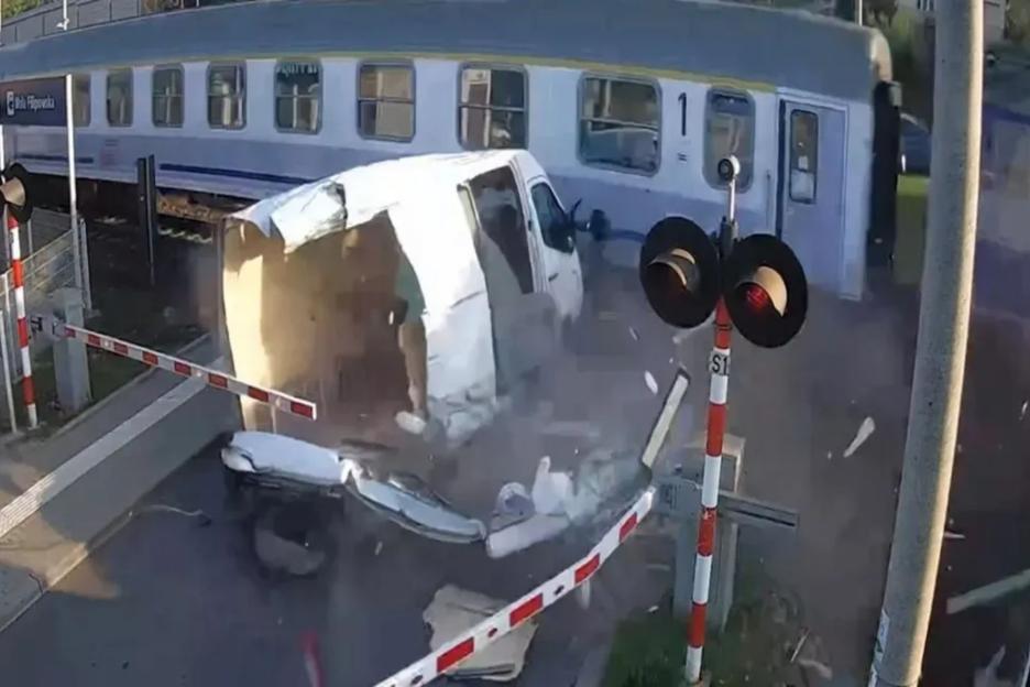 Watch moment idiot driver gets van SMASHED by train after trying to skip barriers at level crossing