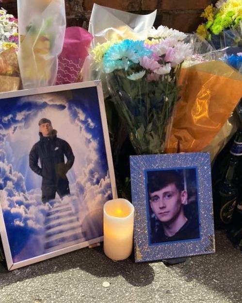 Two framed photos of Dylan Keelan and Nicole Wardle are displayed with flowers and a candle.
