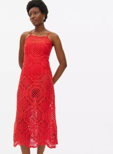 Woman in red midi dress with lace pattern.