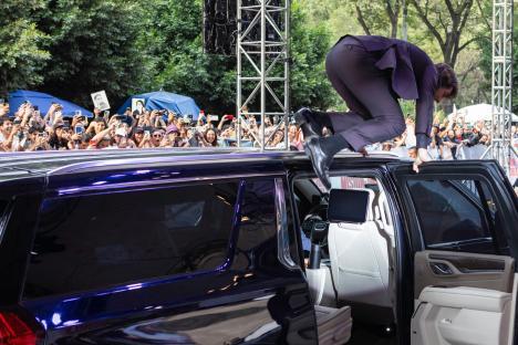 Tom Cruise jumping onto a car at a Mission: Impossible premiere.