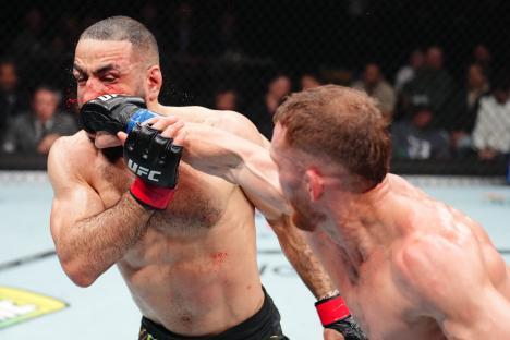 Jack Della Maddalena punches Belal Muhammad in a UFC welterweight championship bout.