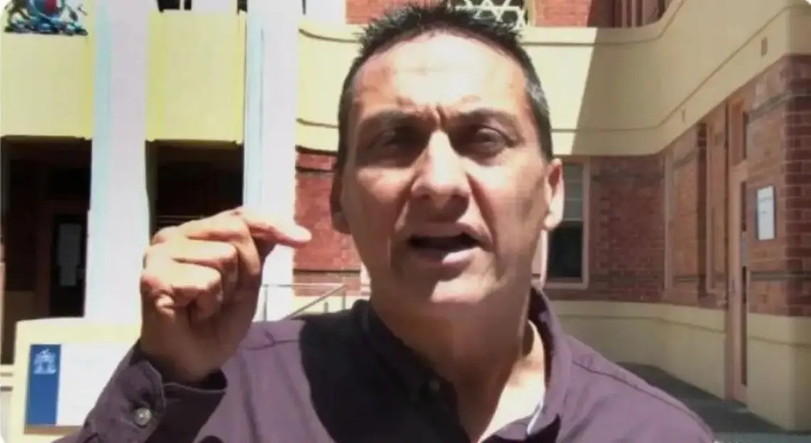 Man speaking outdoors.