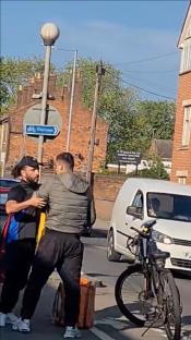 Two delivery drivers arguing in the street.