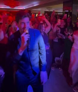 A man singing at a party.