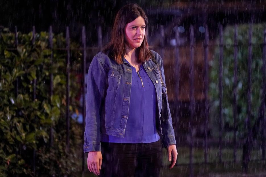 Woman standing in the rain.