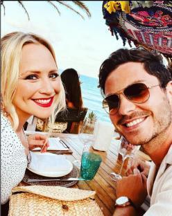 Amy Walsh and Toby Alexander Smith at an outdoor restaurant.