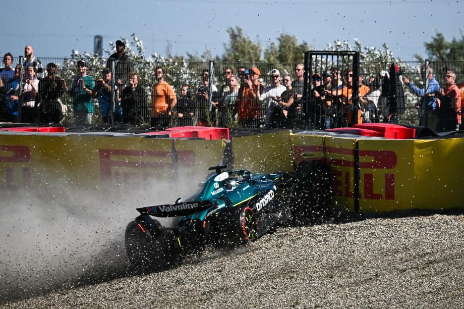 Formula One race car crashing into gravel.