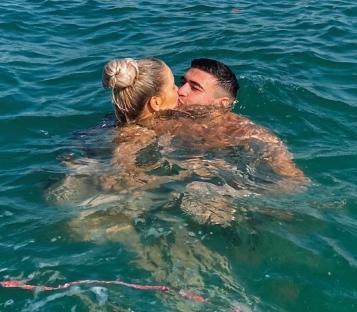 Molly Mae and Tommy Fury kissing in the ocean.