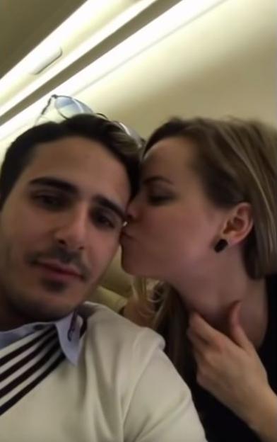 Woman kissing man on a private plane.