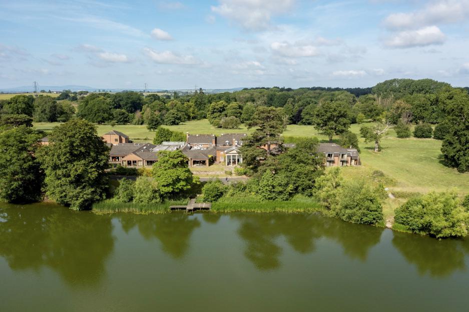 Aerial view of Patshull Park Hotel Golf and Country Club, situated on a lake.