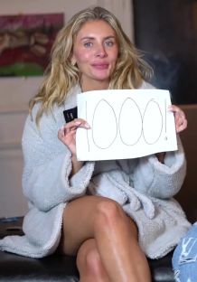 Woman in a robe holding a sign that says