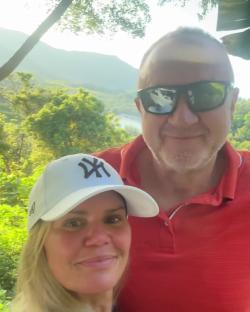 Kerry Katona and a man smiling for a selfie outdoors.