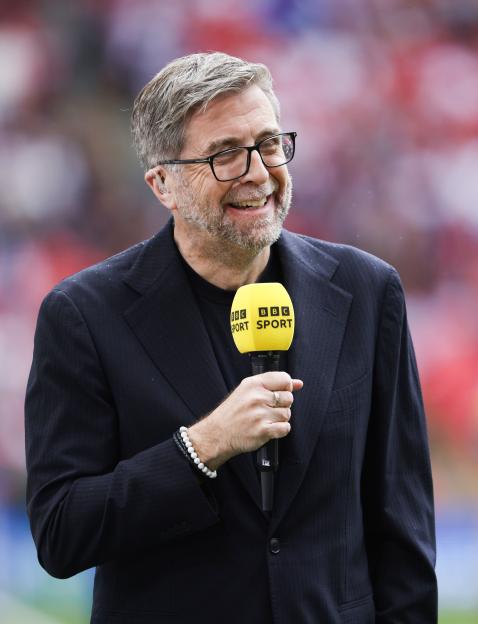 Mark Chapman holding a BBC Sport microphone.