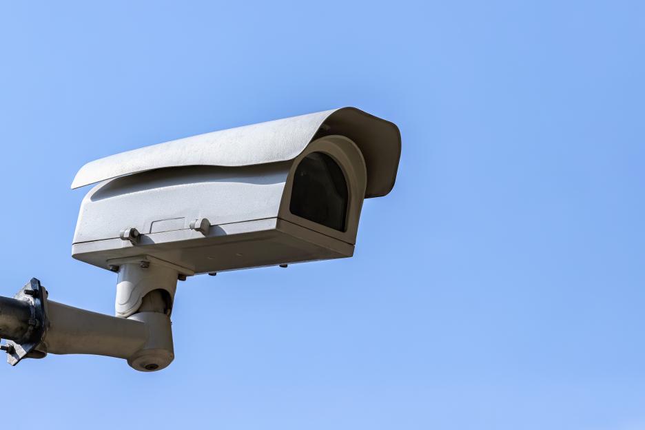 Security camera against a blue sky.