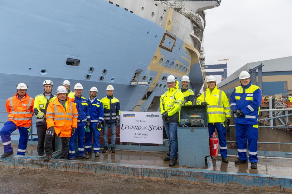 Workers celebrating the launch of the Legend of the Seas cruise ship.