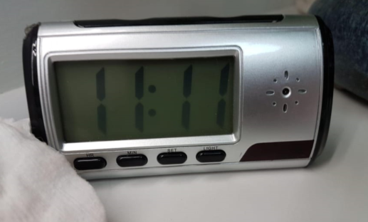 Clock with hidden camera showing the time 1:11.