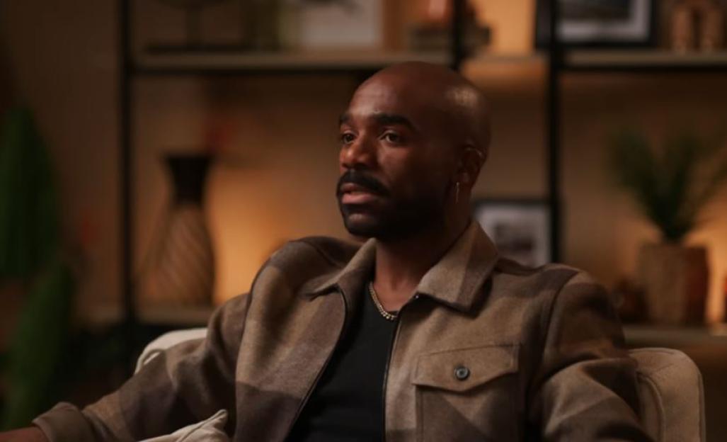 Ore Oduba sits while looking slightly to the left.