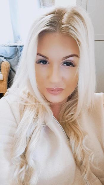 A headshot of Karlene Warner, a woman with long blonde hair, looking directly at the camera.