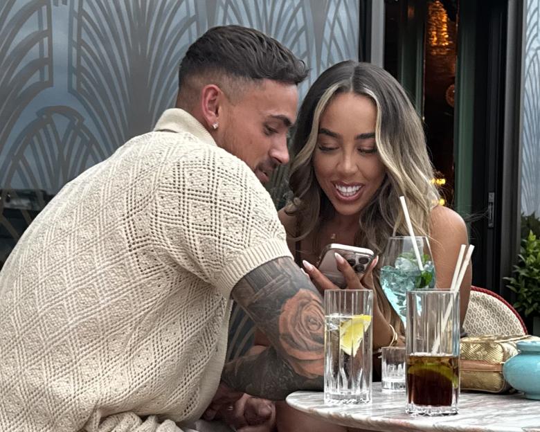 Ben from Love Island and Dani from TOWIE looking at a phone together.