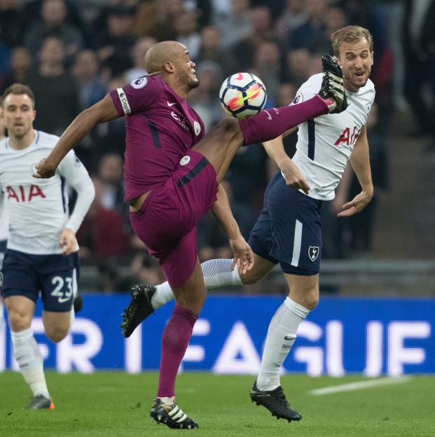 Harry Kane and Vincent Kompany challenge for the ball during a Tottenham Hotspur vs Manchester City English Premiere League match.