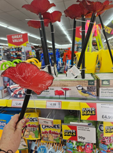 Poppy-shaped bird feeder on display in a store.
