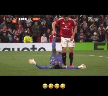 Onana lying on the ground while Maguire holds his leg.