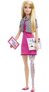 Barbie doll with a prosthetic leg, holding a tablet and architectural plans.