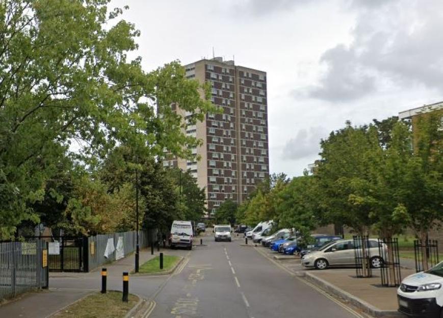 High-rise apartment building viewed from a street.