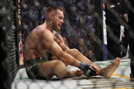 Conor McGregor reacting to an injury during a UFC match.