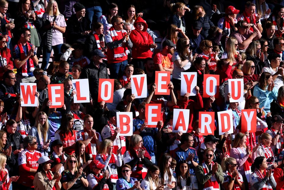 Arsenal fans hold up signs that spell "We Love You Beardy" in tribute to the late Matt Beard.