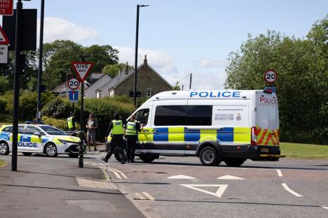 Police and emergency services at a road incident.