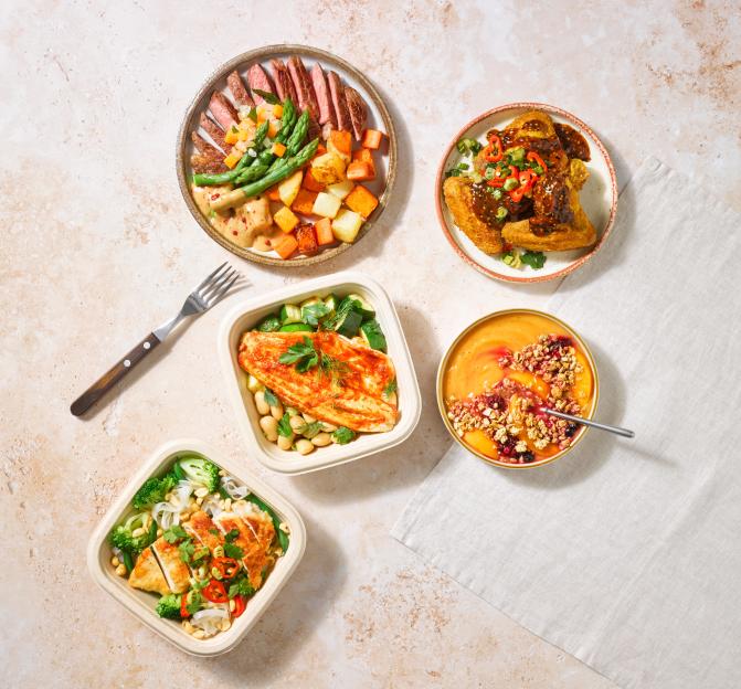 Five prepared meals: steak with vegetables, chicken wings, fish with beans, chicken with rice and broccoli, and a fruit and granola bowl.