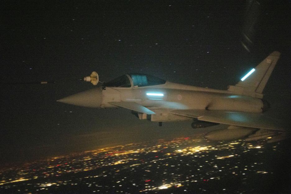 RAF Typhoon FGR4 being refueled by an RAF Voyager over Poland at night.