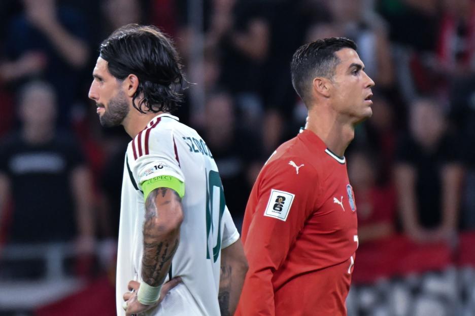 Dominik Szoboszlai and Cristiano Ronaldo during a soccer match.