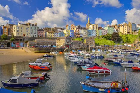 Tenby harbor with colorful buildings and boats.