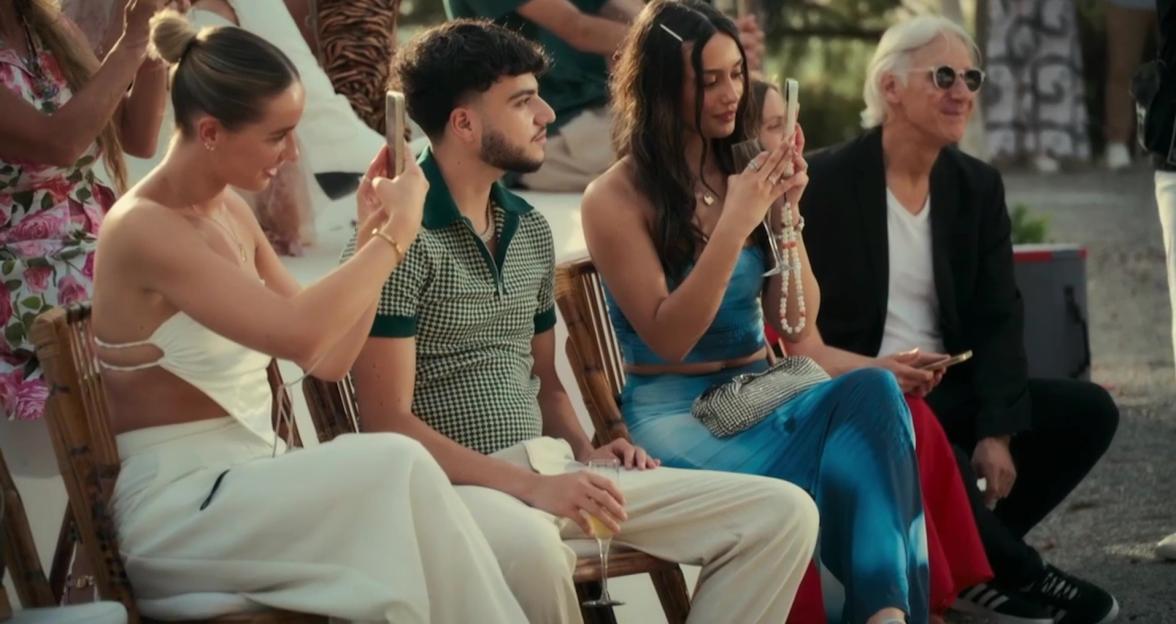 People watching a fashion show on phones.