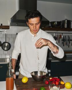 Man seasoning food in a kitchen.
