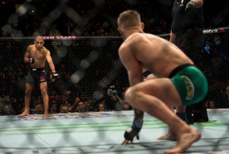 Jose Aldo and Conor McGregor facing off in a UFC match.