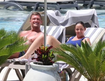 Couple relaxing by a pool.