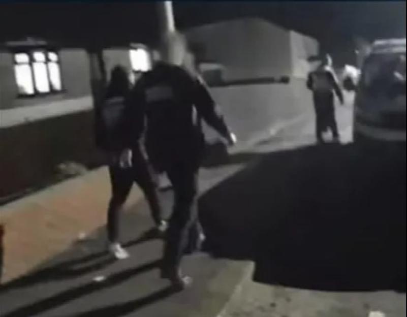 Matthew Battenbough being arrested at night.