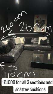 Three-section leather sectional sofa with scatter cushions for £1000.