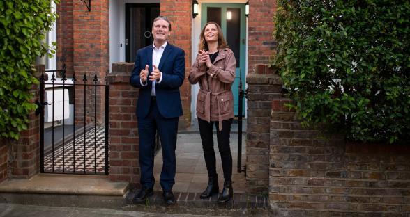 Keir Starmer and his wife applauding outside their home.