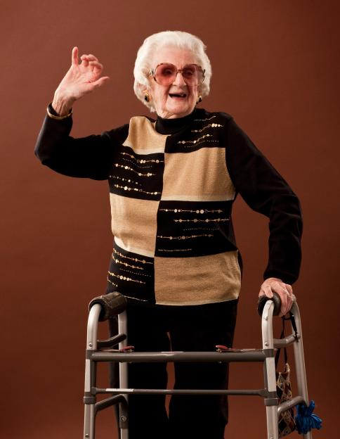 Senior woman dancing with a walker.