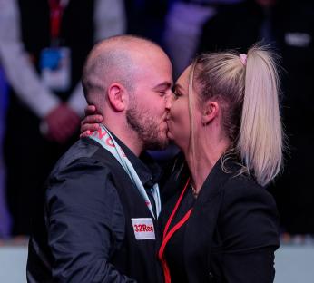 Luca Brecel and Laura Vanoverberghe kissing after he won the Cazoo Snooker World Championship.