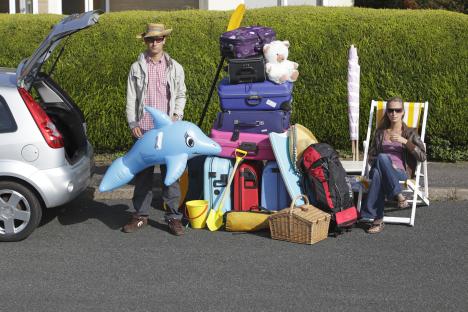 Couple loading a car for a holiday.