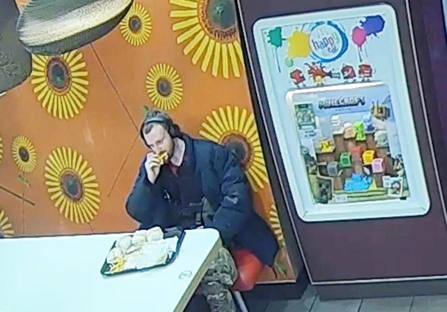 Surveillance image of Jacob Jenkins eating in a McDonald's.
