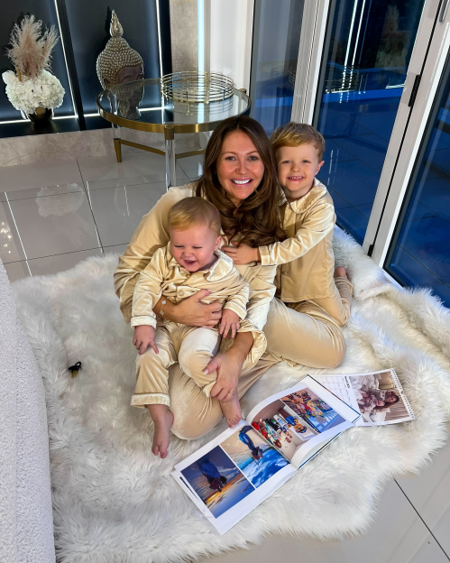 Woman and two children in matching pajamas.